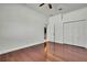 Clean bedroom featuring hardwood floors, closet, white trim, and ample open space for versatile use at 710 W Peninsular St, Tampa, FL 33603