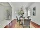 Dining room showcasing a modern light fixture, hardwood floors, and views of the front entrance at 710 W Peninsular St, Tampa, FL 33603