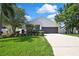 Charming single Gathering home with manicured lawn, landscaped garden beds and a two car garage at 710 W Peninsular St, Tampa, FL 33603