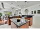 Spacious open-concept kitchen with black granite countertops, wood cabinetry, and modern pendant lighting at 710 W Peninsular St, Tampa, FL 33603