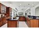 Gourmet kitchen with dark countertops, wooden cabinets, and stainless steel appliances at 710 W Peninsular St, Tampa, FL 33603