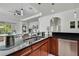 Elegant kitchen showcasing a modern sink, granite countertops, and stainless steel appliances at 710 W Peninsular St, Tampa, FL 33603