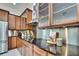 Close-up of modern kitchen with stainless steel appliances, dark countertops, and ample cabinet space at 710 W Peninsular St, Tampa, FL 33603