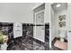 Elegant bathroom with marble accents, white cabinets, and a glass-enclosed shower stall at 710 W Peninsular St, Tampa, FL 33603