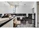 Luxurious main bathroom featuring black marble, a makeup vanity, and a chandelier at 710 W Peninsular St, Tampa, FL 33603