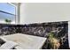 Bathroom showcasing marble accents, a soaking tub, and tile backsplash at 710 W Peninsular St, Tampa, FL 33603