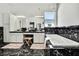 Luxurious bathroom with a soaking tub, marble accents, vanity area, and decorative chandelier at 710 W Peninsular St, Tampa, FL 33603