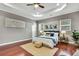 Spacious main bedroom with tray ceiling, hardwood floors, area rug and decorative accent pieces at 710 W Peninsular St, Tampa, FL 33603