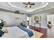 Spacious main bedroom featuring hardwood floors, tray ceiling, and access to main bathroom at 710 W Peninsular St, Tampa, FL 33603