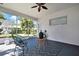 The screened patio featuring a ceiling fan and seating area invites relaxation and outdoor enjoyment at 710 W Peninsular St, Tampa, FL 33603