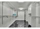 Walk-in closet featuring custom shelving, storage space, and marble floors at 710 W Peninsular St, Tampa, FL 33603