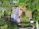 Aerial view showcases the home's roof, brick patio, garden, and yard surrounded by mature trees at 7219 4Th N Ave, St Petersburg, FL 33710