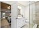 A bright, remodeled bathroom with a glass shower, wood-look tile, and white marble vanity at 7219 4Th N Ave, St Petersburg, FL 33710