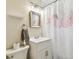 Clean bathroom featuring flamingo shower curtain, mirror, and vanity sink at 7219 4Th N Ave, St Petersburg, FL 33710