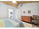 Bedroom featuring a ceiling fan, ensuite laundry, hardwood floors, and ample closet space at 7219 4Th N Ave, St Petersburg, FL 33710