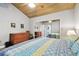 Cozy bedroom featuring a wooden ceiling, hardwood floors, a spacious closet, and a charming dresser at 7219 4Th N Ave, St Petersburg, FL 33710