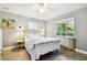 Cozy bedroom featuring wood floors, ceiling fan, and a bright window at 7219 4Th N Ave, St Petersburg, FL 33710