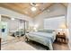 Bright bedroom with wood-look floors, ceiling fan, closet, and natural light from the window at 7219 4Th N Ave, St Petersburg, FL 33710