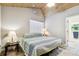 Relaxing bedroom with light-colored walls, wood floors, ensuite bath, and ample natural light from a window at 7219 4Th N Ave, St Petersburg, FL 33710
