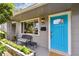 Close up of a home entry featuring a bench and a bright blue front door at 7219 4Th N Ave, St Petersburg, FL 33710