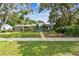 Charming single-story home features a bright blue front door, green lawn, and mature landscaping at 7219 4Th N Ave, St Petersburg, FL 33710