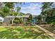 A charming single-story home showcases a well-manicured lawn and bright blue front door at 7219 4Th N Ave, St Petersburg, FL 33710