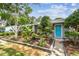 Inviting single-story home with a colorful front garden and a bright blue door at 7219 4Th N Ave, St Petersburg, FL 33710
