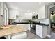 Well-lit kitchen featuring stainless steel appliances, white cabinetry, and a functional center island at 7219 4Th N Ave, St Petersburg, FL 33710