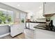 Modern kitchen featuring white cabinets, black countertops, and stainless steel appliances at 7219 4Th N Ave, St Petersburg, FL 33710