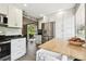 Bright kitchen with white cabinets, stainless appliances, and open layout to adjacent living spaces at 7219 4Th N Ave, St Petersburg, FL 33710