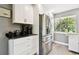 Kitchen features stainless steel refrigerator, ample cabinet space, and natural light at 7219 4Th N Ave, St Petersburg, FL 33710