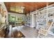 Charming living room features wood-paneled ceiling, bookshelves, ample natural light, and classic piano at 7219 4Th N Ave, St Petersburg, FL 33710