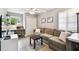 Living room with light gray walls, desk, and comfortable couch at 7219 4Th N Ave, St Petersburg, FL 33710