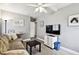 Cozy living room with gray walls, television, and wood-look flooring at 7219 4Th N Ave, St Petersburg, FL 33710