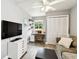 Living room features a ceiling fan, closet, and modern desk space at 7219 4Th N Ave, St Petersburg, FL 33710