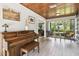 Inviting living room with a piano, wood ceilings, and cozy seating area with natural light streaming in at 7219 4Th N Ave, St Petersburg, FL 33710