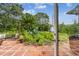 View of lush backyard through glass patio doors onto brick paver patio and landscaping at 7219 4Th N Ave, St Petersburg, FL 33710