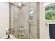 Bathroom shower featuring natural light, river rock flooring, and tile walls at 7219 4Th N Ave, St Petersburg, FL 33710