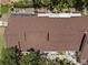 Birds eye view of the roof and surrounding landscape with an interesting tree covering at 7705 4Th W Ave, Bradenton, FL 34209