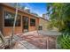 Brick patio with outdoor seating and tropical backyard landscaping at 7705 4Th W Ave, Bradenton, FL 34209