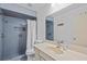 Blue tiled bathroom with shower, vanity, and decorative mirror at 7705 4Th W Ave, Bradenton, FL 34209
