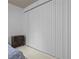 Bedroom with neutral walls, window blinds, and side table with drawer at 7705 4Th W Ave, Bradenton, FL 34209