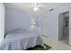 Light blue bedroom featuring a ceiling fan, closet, and ensuite bathroom at 7705 4Th W Ave, Bradenton, FL 34209