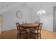 Cozy dining area featuring hardwood floors and a stylish chandelier at 7705 4Th W Ave, Bradenton, FL 34209