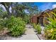 Landscaped front entrance featuring lush greenery and a walkway at 7705 4Th W Ave, Bradenton, FL 34209