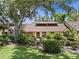 Inviting home exterior showcases lush landscaping and a charming facade, creating a welcoming curb appeal at 7705 4Th W Ave, Bradenton, FL 34209
