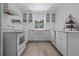 Bright kitchen features white cabinets, a farmhouse sink, and modern appliances at 7705 4Th W Ave, Bradenton, FL 34209