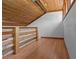 Loft space featuring wood floors, wood-paneled ceiling, and natural wood railings at 7705 4Th W Ave, Bradenton, FL 34209