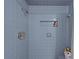 A tiled shower stall with a shower head and built-in storage niche at 7705 4Th W Ave, Bradenton, FL 34209