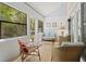 Bright sunroom with comfortable seating, natural light and wood flooring at 7705 4Th W Ave, Bradenton, FL 34209